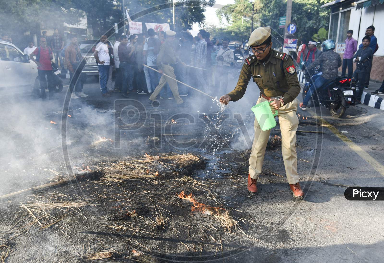 Assam Police Man Stopping The Fire Created by Protesters Against CAA, CAB And NRC  In Guwahati