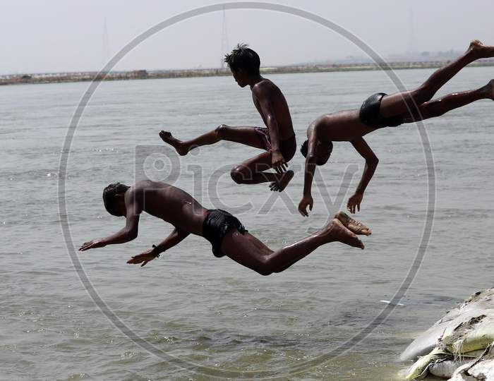 Boys Jump In The Ganga River To Beat The Heat On A Hot Summer In Prayagraj,