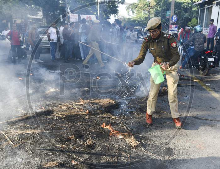 Assam Police Man Stopping The Fire Created by Protesters Against CAA, CAB And NRC  In Guwahati