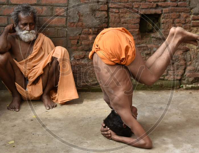 Hindu Holy Men Perform Yoga To Hindu Holy Men Perform Yoga To Mark International Yoga Day At Kamakhya Temple In Guwahati As aPart Of  International Yoga Day At Kamakhya Temple In Guwahati In The Indian State Of Assam