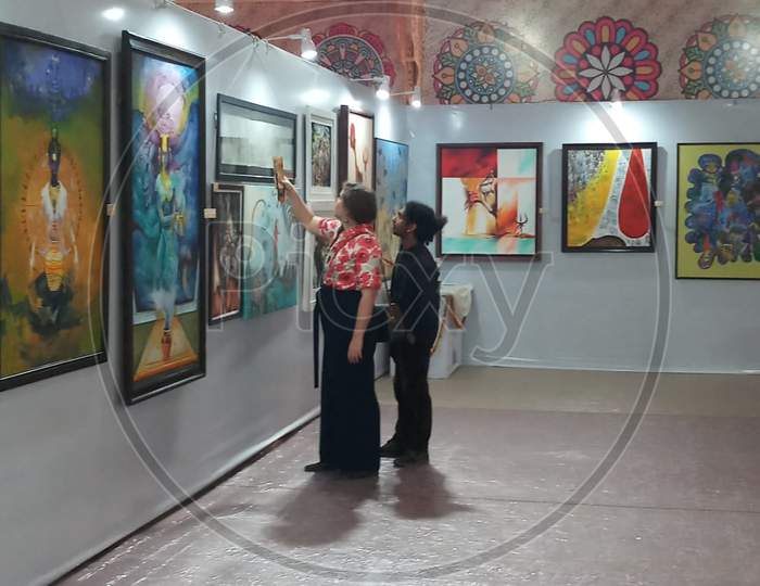 Visitors At an Art Gallery With Paints Exhibition
