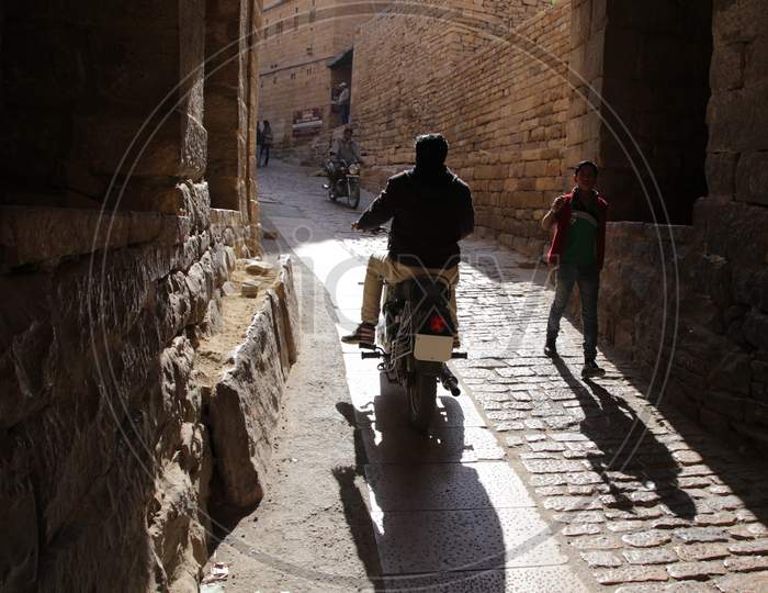 A Man riding a bullet through the streets of Jaisalmer