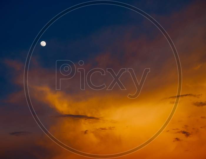 Dark Clouds With Sunset Blue Hour Sky  With Moon