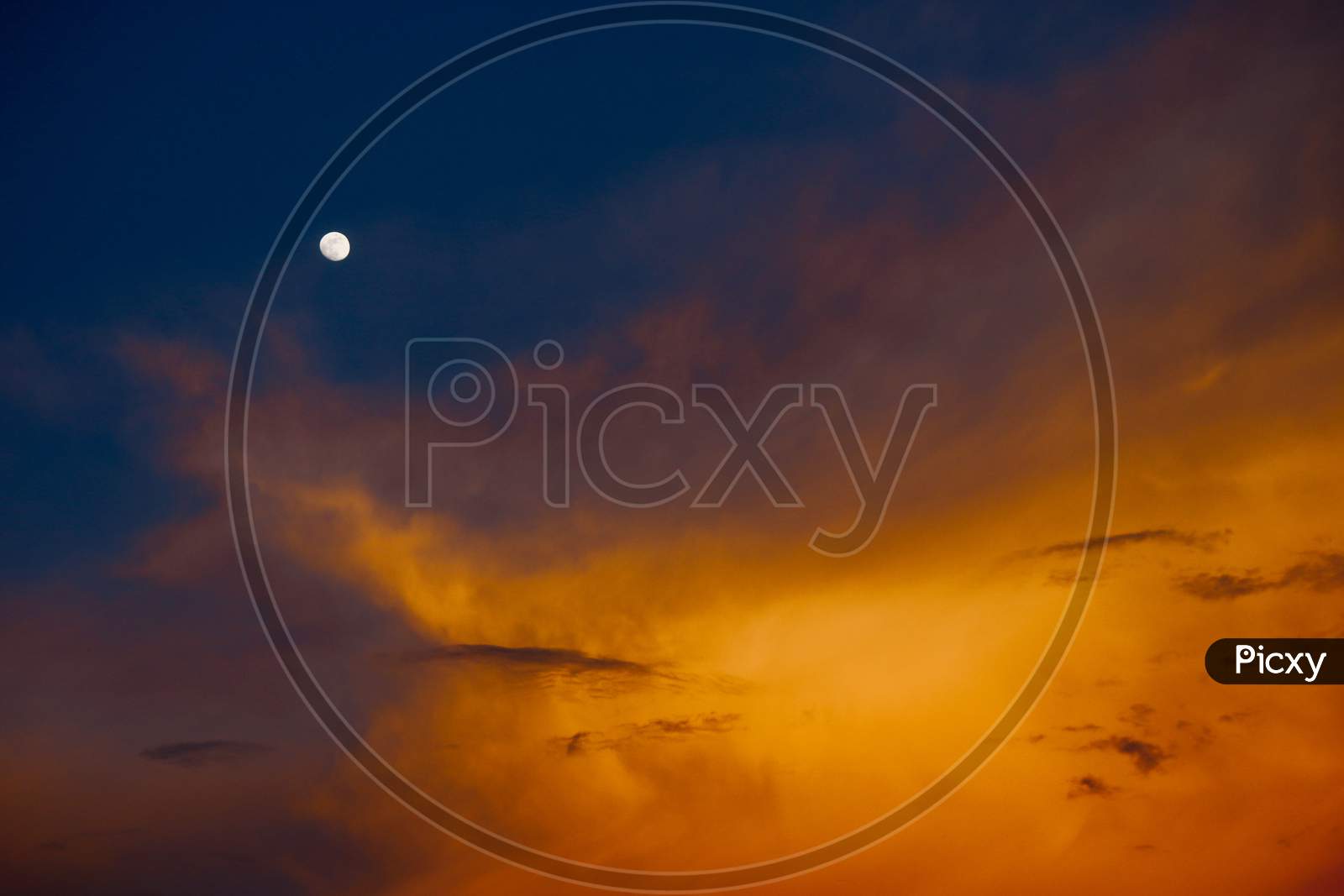 Dark Clouds With Sunset Blue Hour Sky  With Moon
