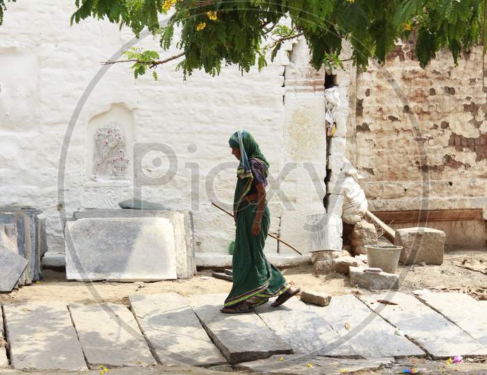 Indian Female Sweeper in Hampi Temple