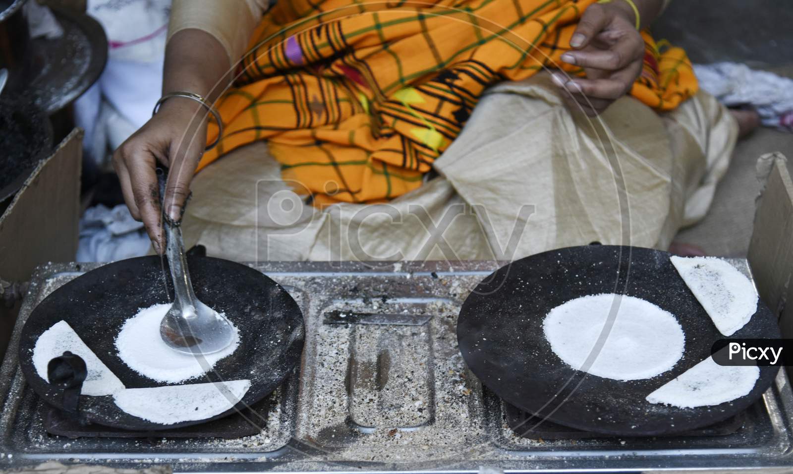 Assamese Woman Prepares Traditional Food, Pitha, Ahead Of Bhogali Bihu Or Magh Bihu, In Guwahati,