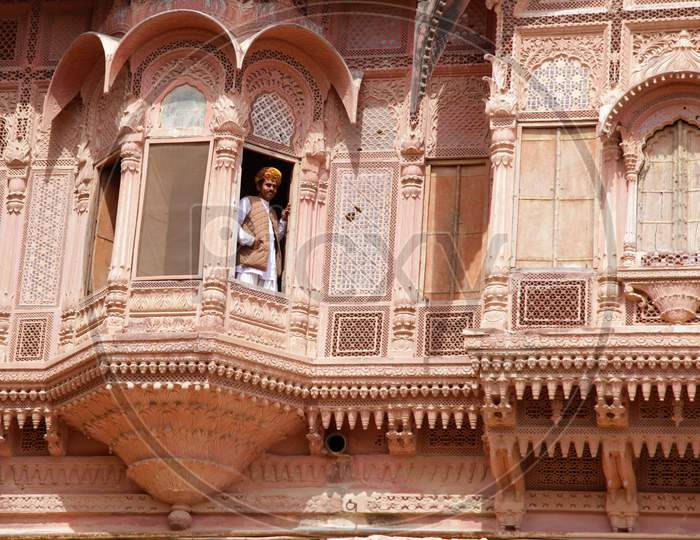 A Rajasthani man looking out from Mehrangarh Fort and Museum window