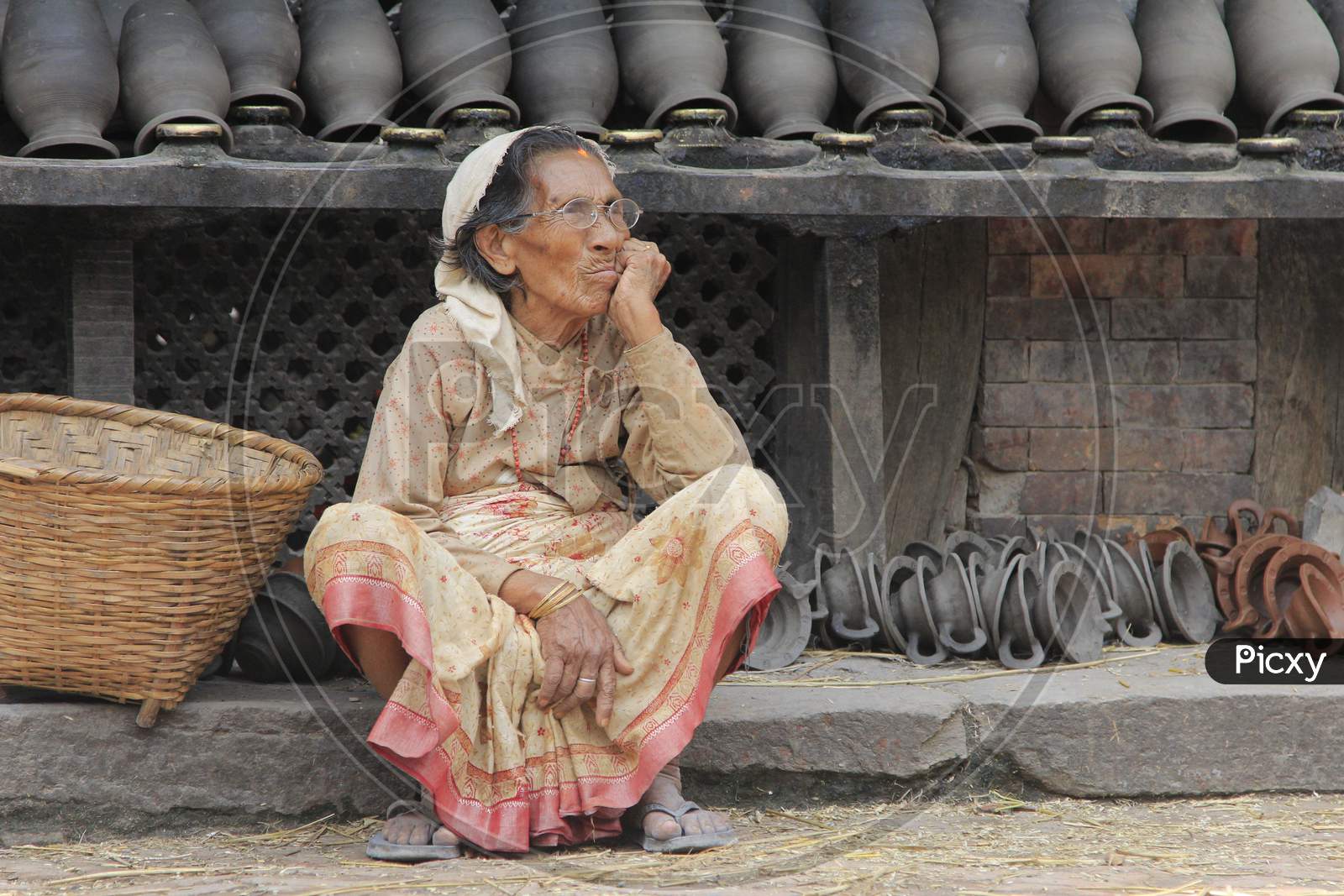 Indian old woman waiting