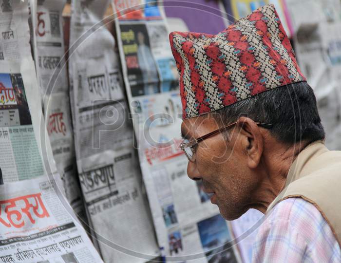 A Nepalese man reading Newspaper