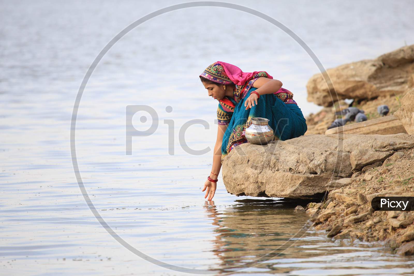 A Rajasthani Woman Collecting  Water For Pooja  From Gadisar Lake  In Jaisalmer, Rajasthan