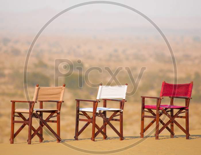 Wooden Chairs At Dessert Sand Dunes