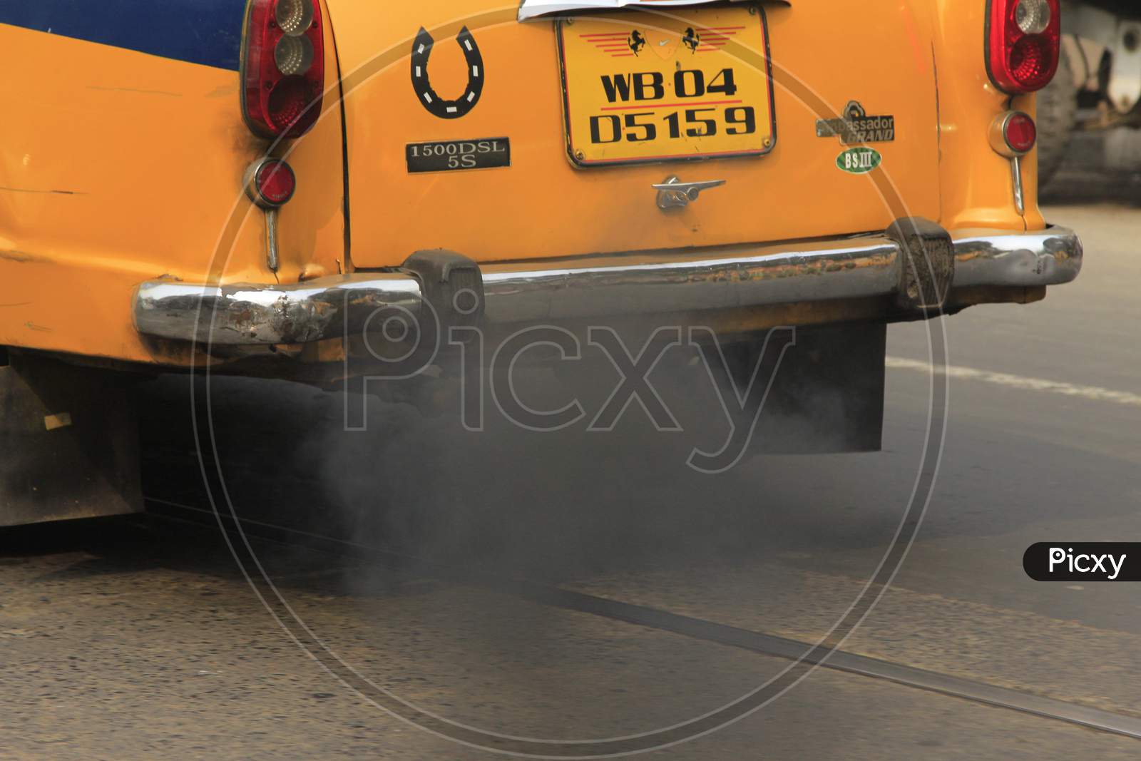 Exhaust smoke coming out from a Taxi