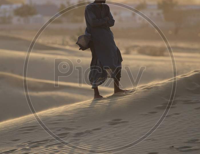 A Rajasthani man standing on the desert