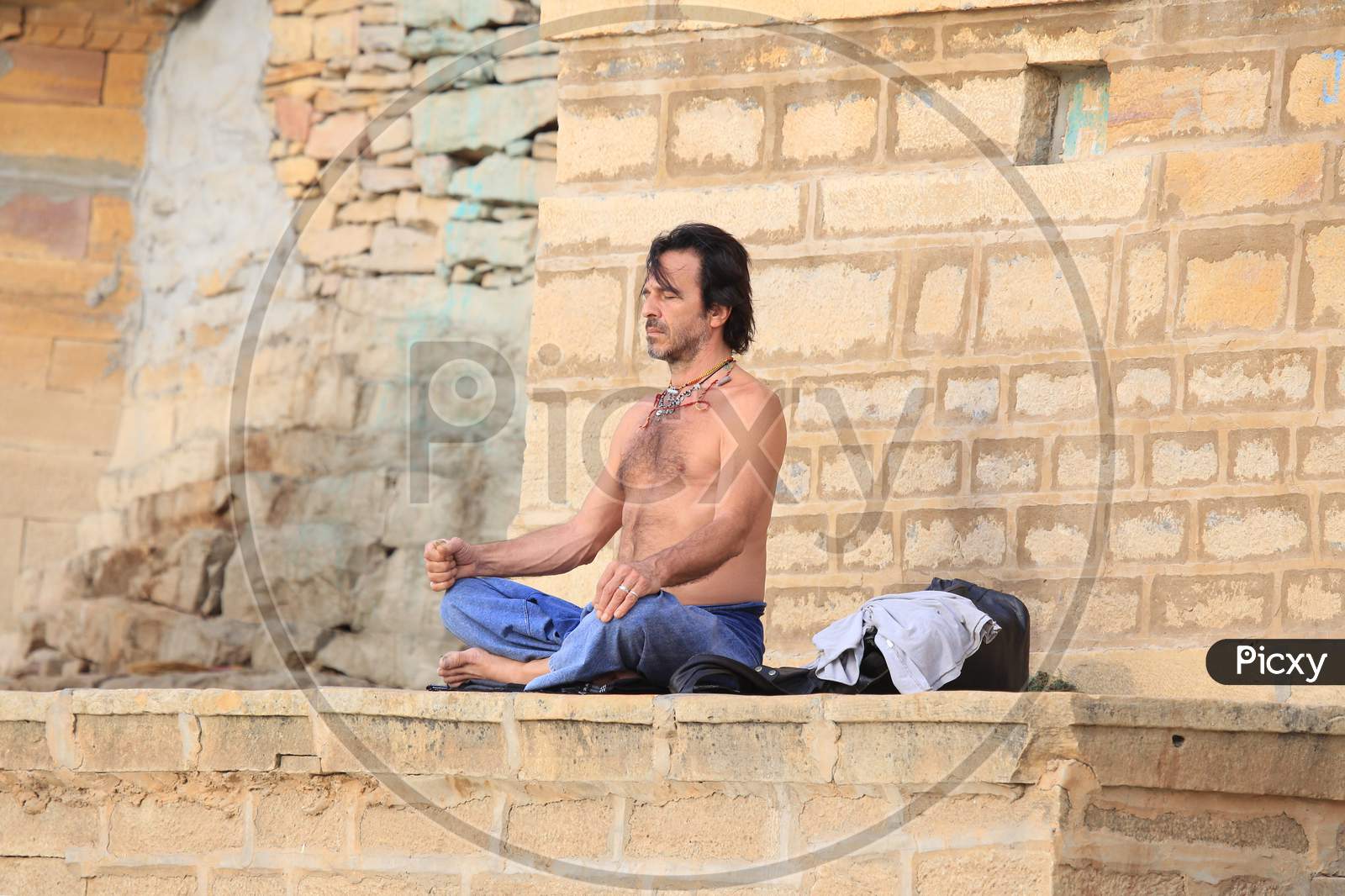 A Man Performing  Yoga At The bank Of Gadisar Lake  in Jaisalmer