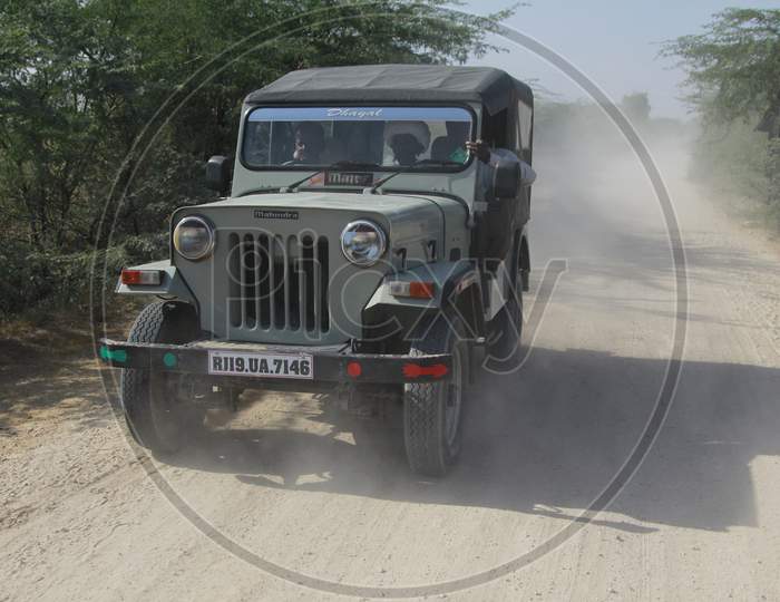 A Jeep moving on the dirt road