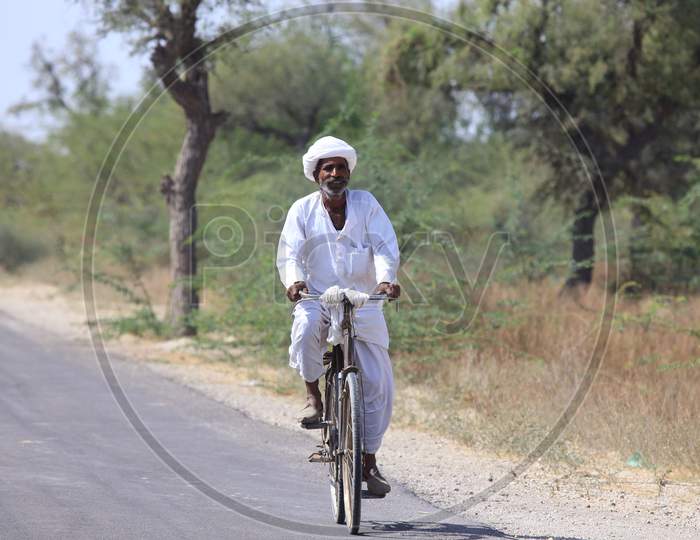 Rajasthani man riding bicycle on the road
