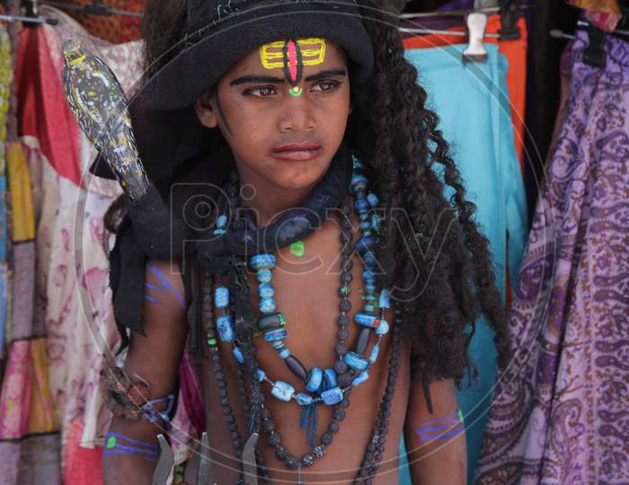 Indian boy dressed up as Lord Shiva