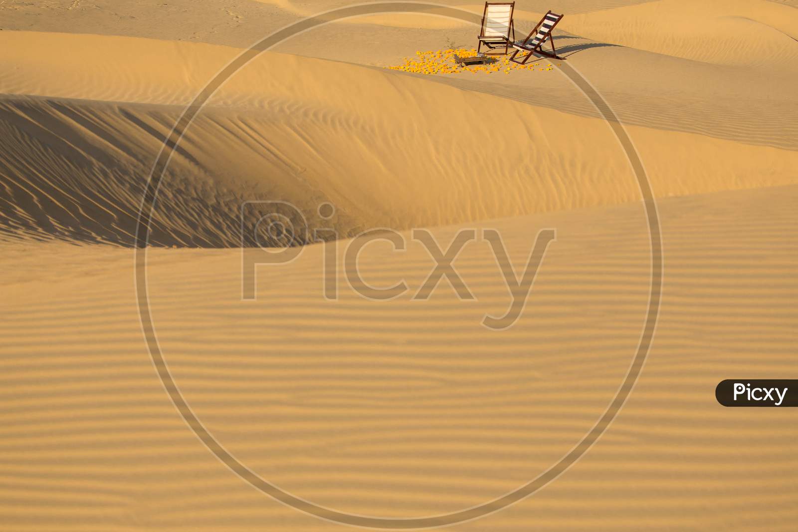 Wooden Chairs At Dessert Sand Dunes