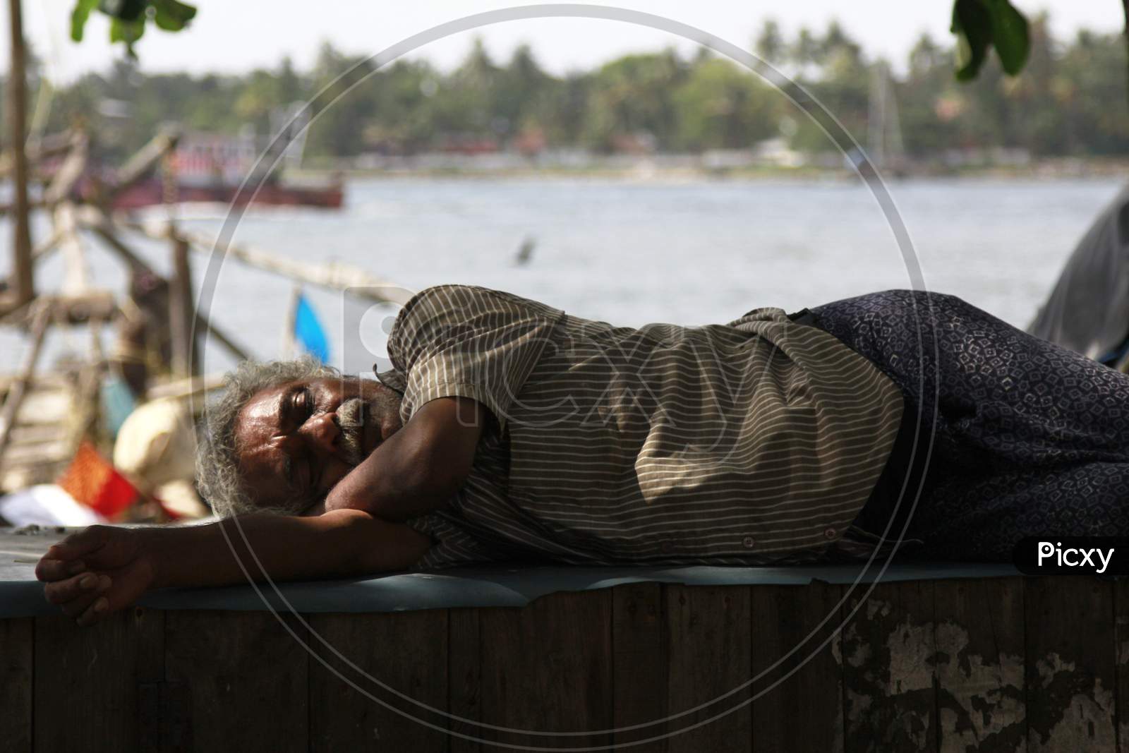Indian Old Man sleeping on the wooden table