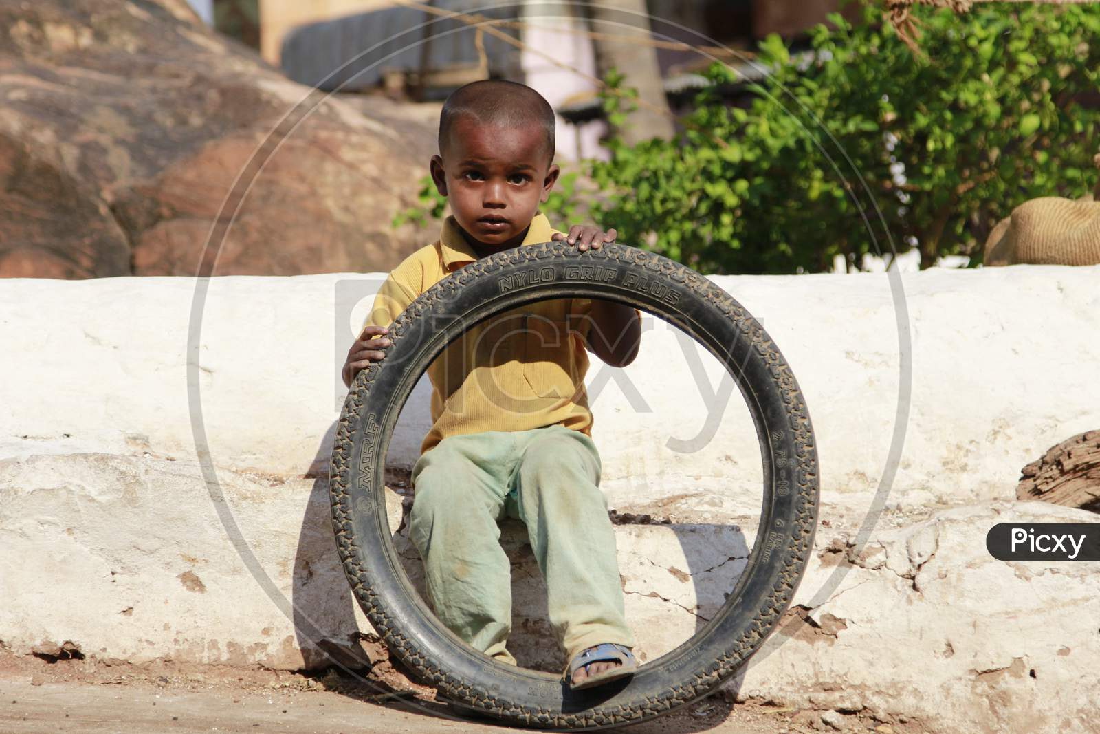 Indian Little boy holding Tyre