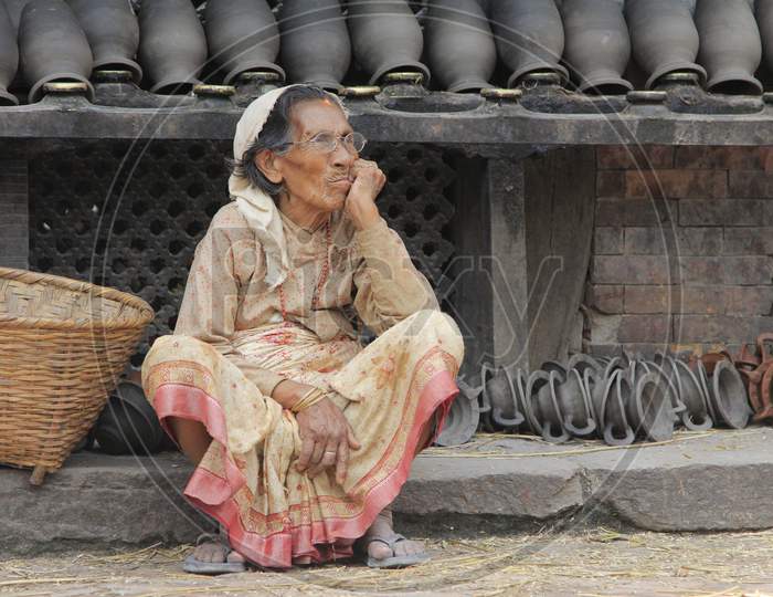 Indian old woman waiting