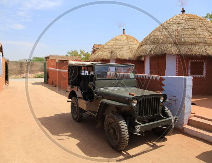 A Jeep by the mud huts in Jodhpur, Rajasthan, India