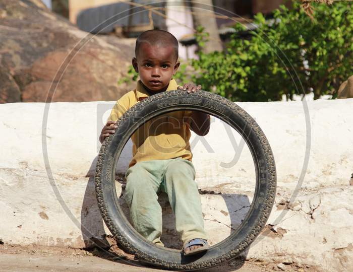 Indian Little boy holding Tyre