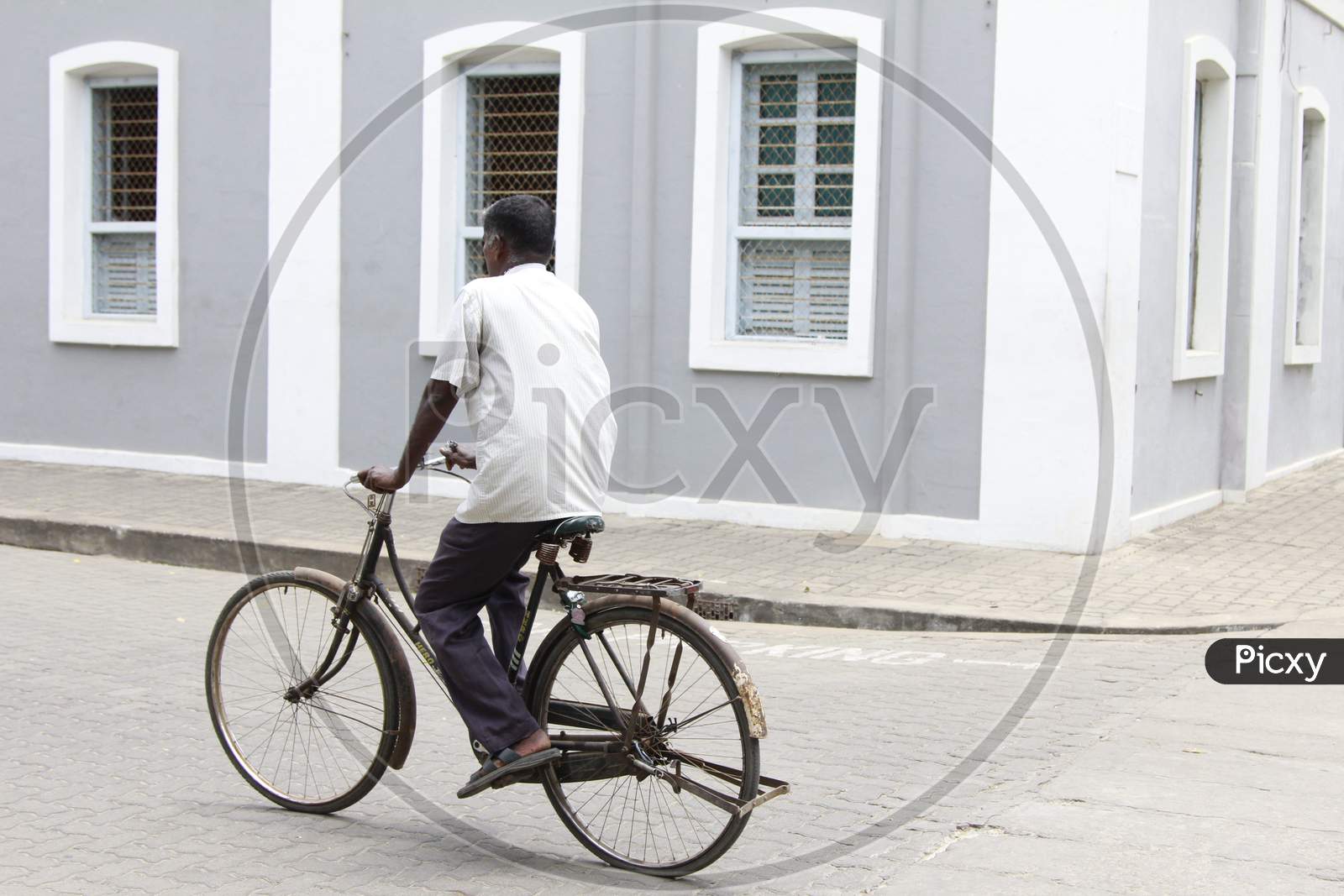 Indian man riding bicycle in the Pondicherry