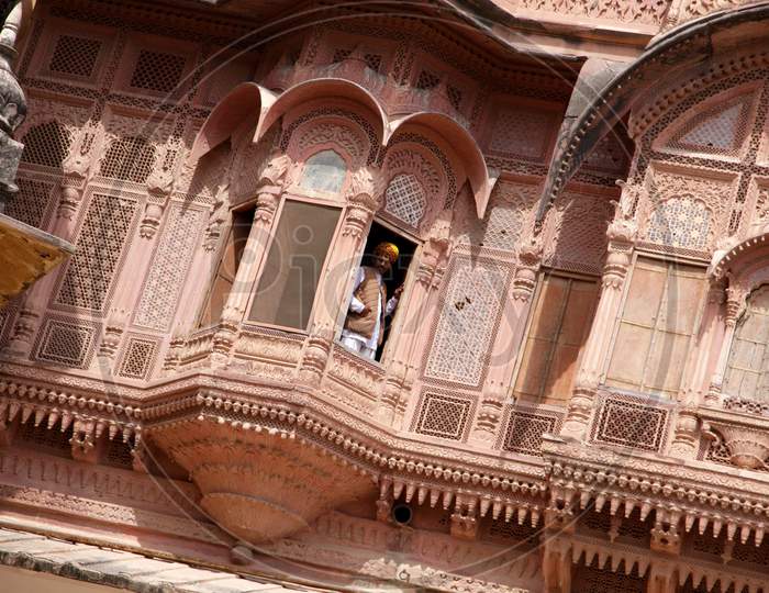 A Jodhpur man peeping out of a Mehrangarh Fort and Museum Window