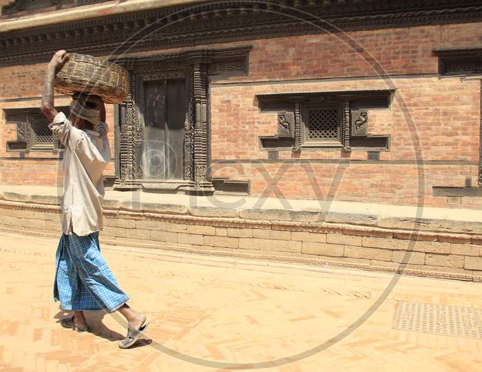 Indian Man carrying a basket on his head