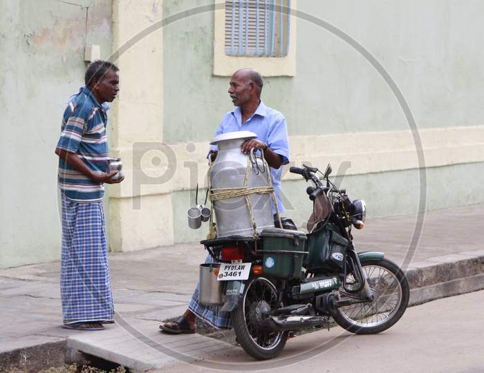 Indian Milkman having a conversation