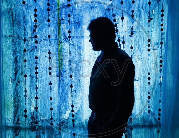 Silhouette of a Man standing in low light