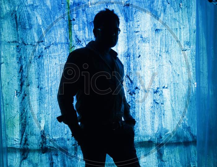 Silhoutte of a man posing wearing formal outfit