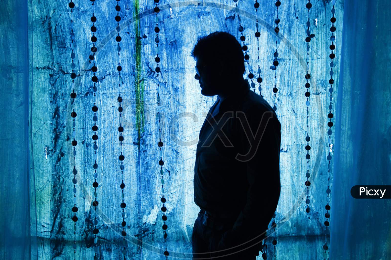 Silhouette of a Man standing in low light