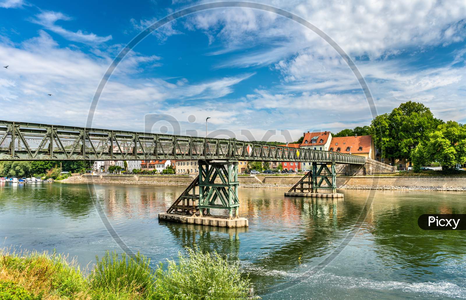 Eiserner Steg Bridge Across The Danube River In Regensburg, Germany
