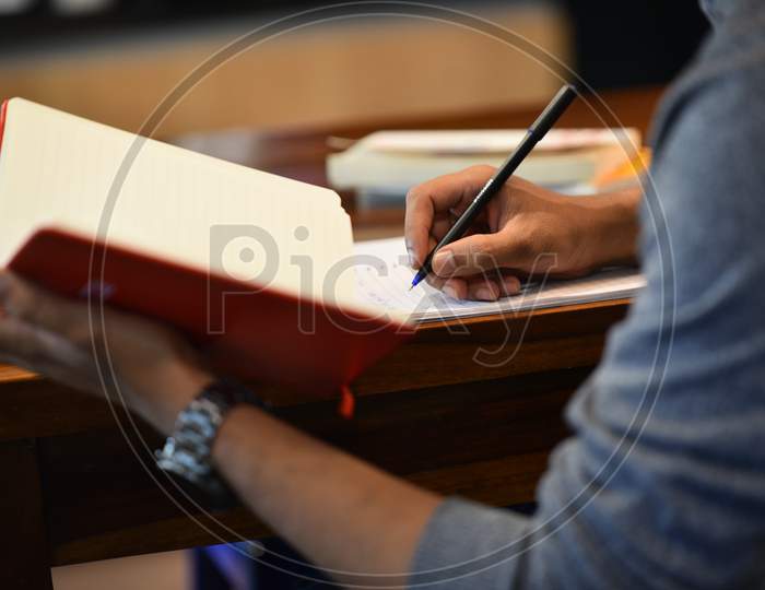 a man writing in a notebook