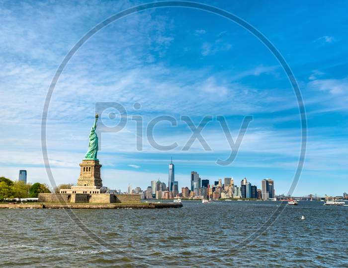 The Statue Of Liberty And Manhattan, New York City