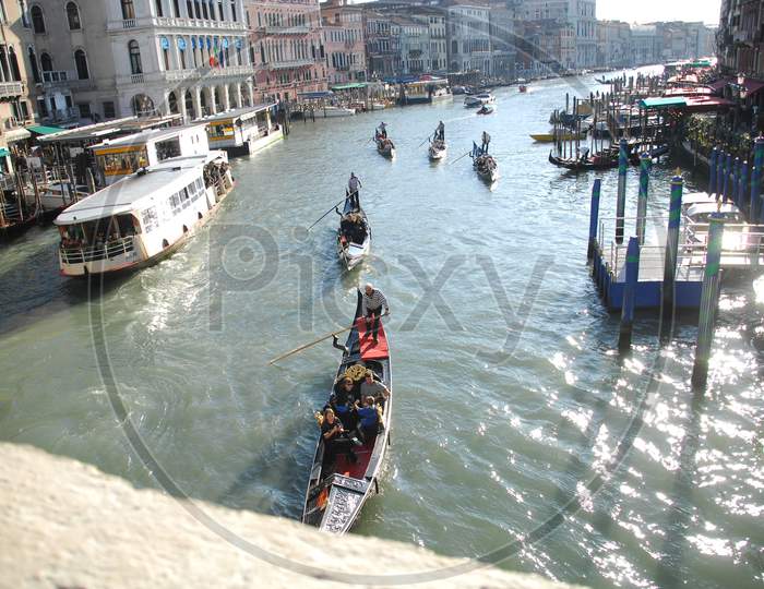 Tourists enjoying the gondola boat rides through the Grand canal