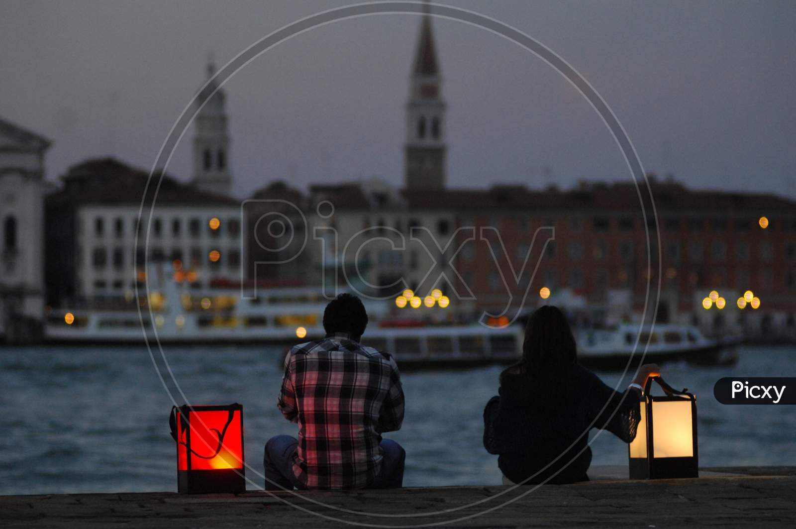 A Couple sitting with lanterns