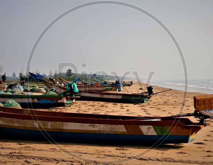 Fishing Boats In a Row At a  Beach