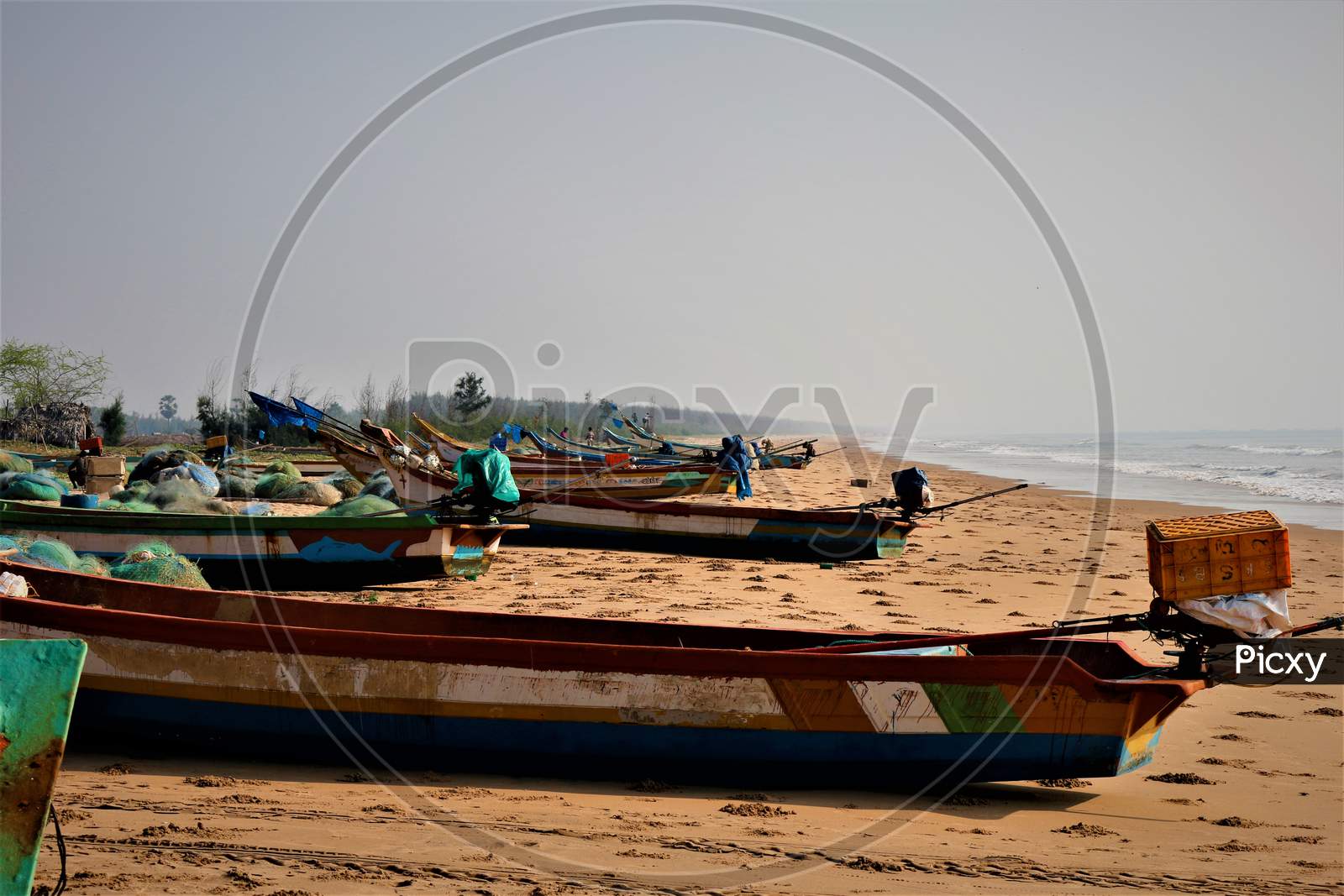 Fishing Boats In a Row At a  Beach