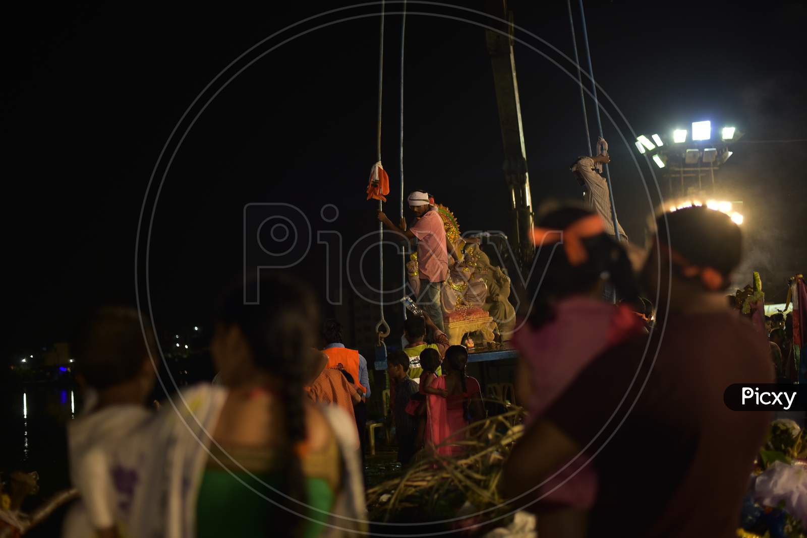 A Happy Family Watching  Ganesh Statue Immersion  At IDL Lake In Hyderabad