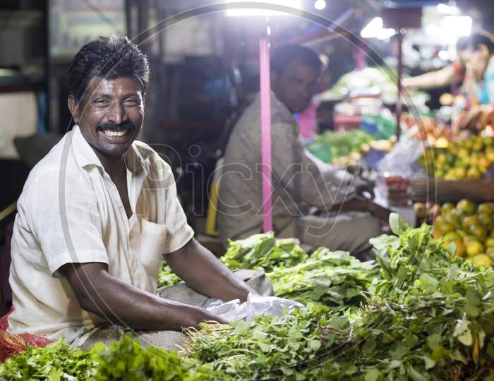 smiling vegetable seller in market