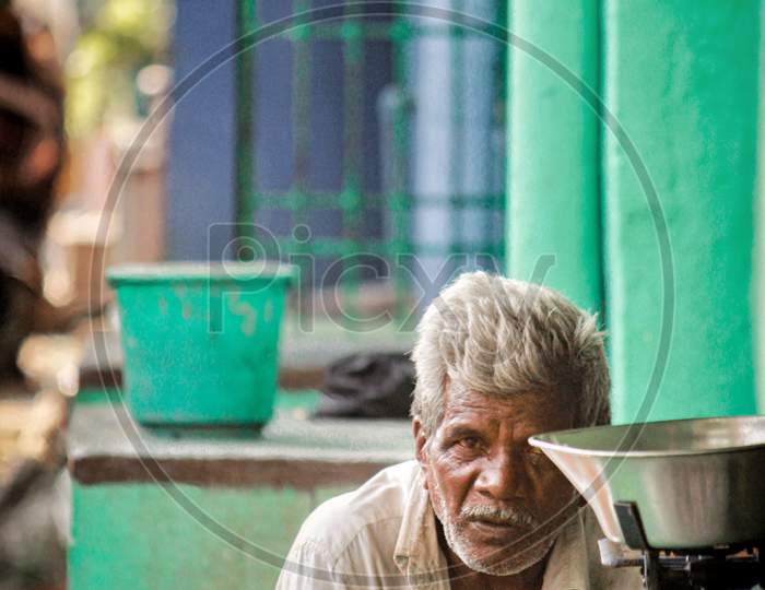 An Elderly Man At a Street Food Stall