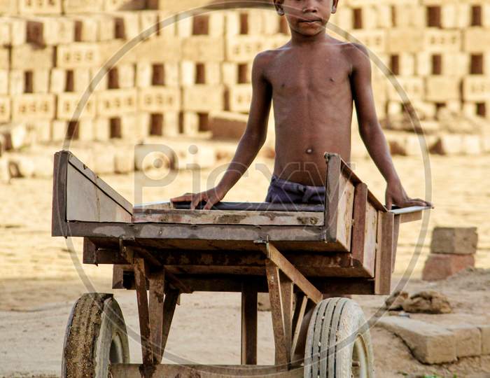 A boy working in a brickyard, Child Labor