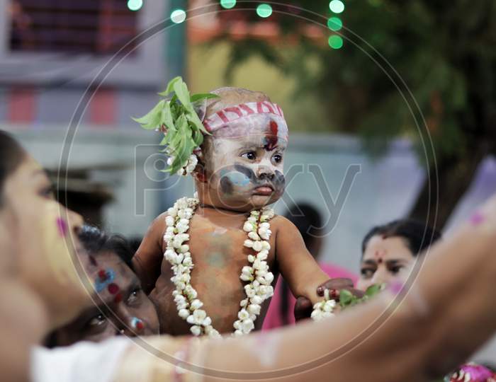 Baby boy dresses accordingly in a local festival