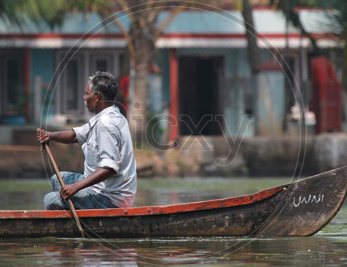Indian Old Man Rowing Boat at Alappuzha, Kerala, India