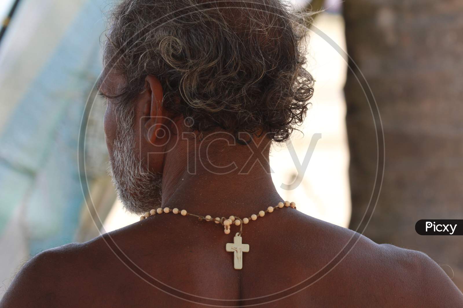 A Fisher Man Wearing a Christ  Chain In Kerala