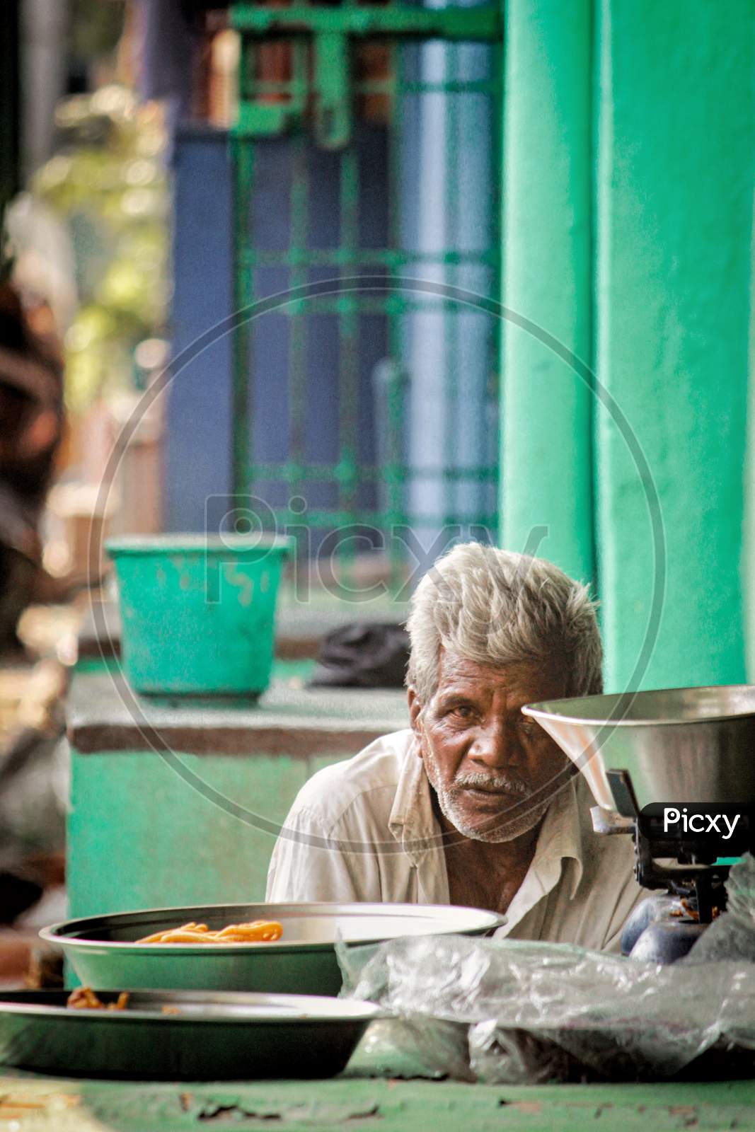 An Elderly Man At a Street Food Stall