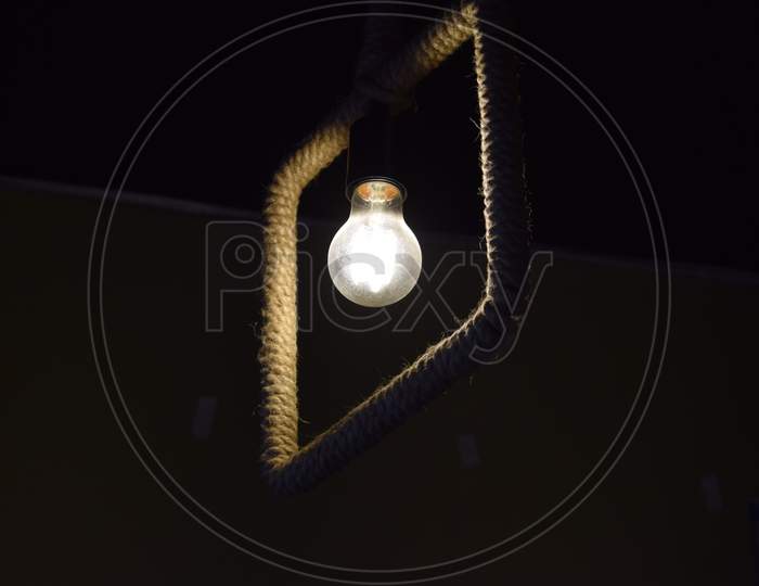 Electric Filament Bulb On Dark Background
